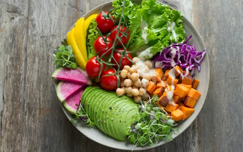Colourful balanced bowl of vegetables, chickpeas and avocado, illustrating a healthy diet plan for women