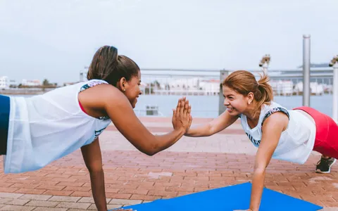 Two women training together and encouraging each other, the supportive side of a female personal trainer in Phuket