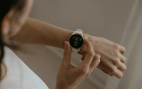Woman checking her fitness watch to plan how often to train with a personal trainer