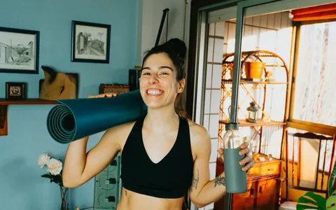 A woman doing an online personal training session at home in Phuket