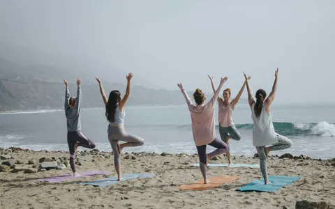 Women doing beach yoga on holiday in Phuket