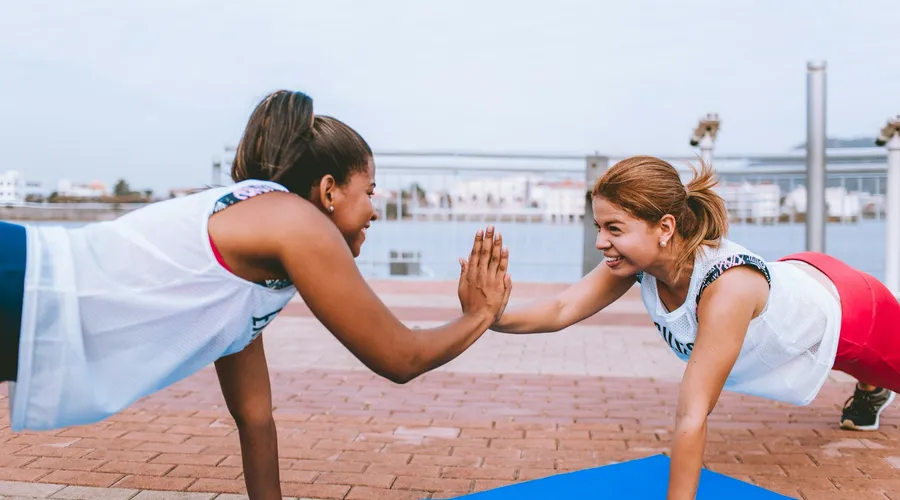Two women training together and encouraging each other, the supportive side of a female personal trainer in Phuket