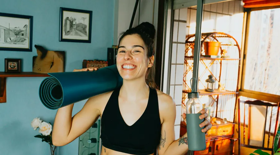 A woman doing an online personal training session at home in Phuket
