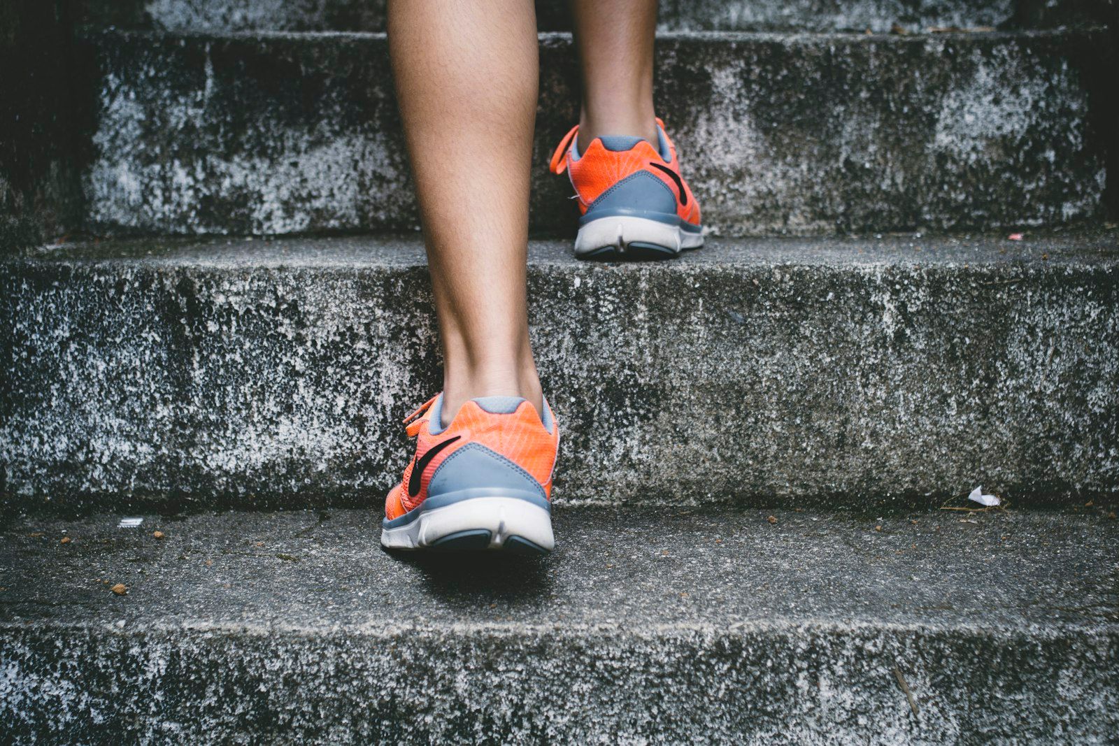 Close-up of running shoes climbing steps, starting a beginner fitness routine in Phuket