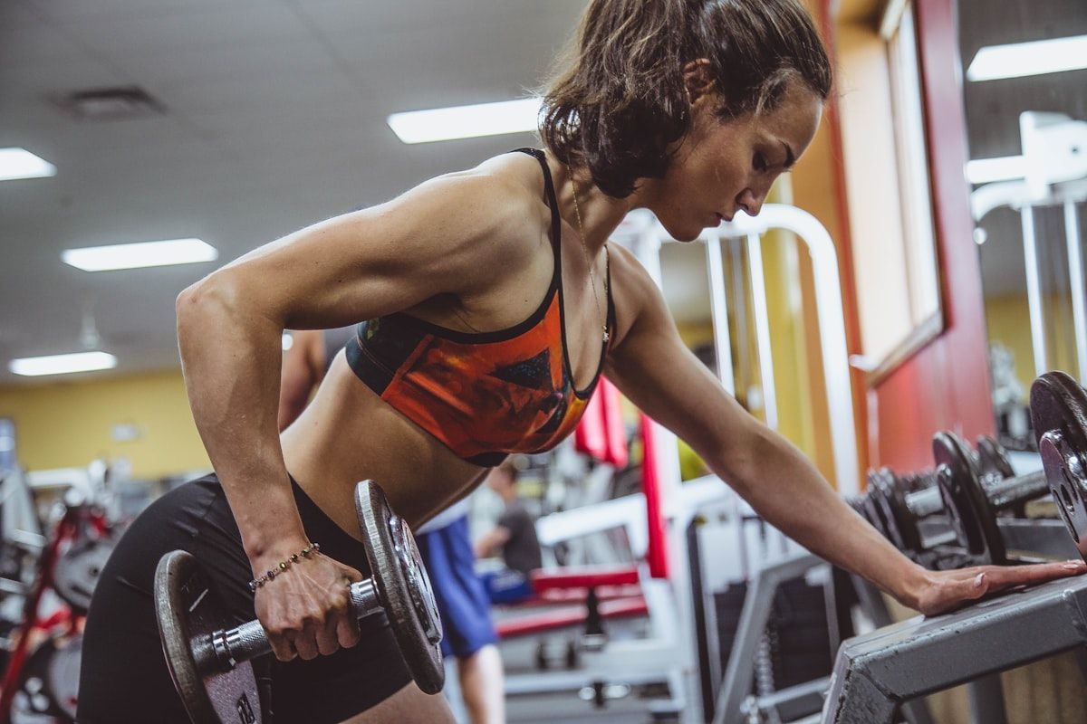 Woman training with a coach twice a week in a bright studio