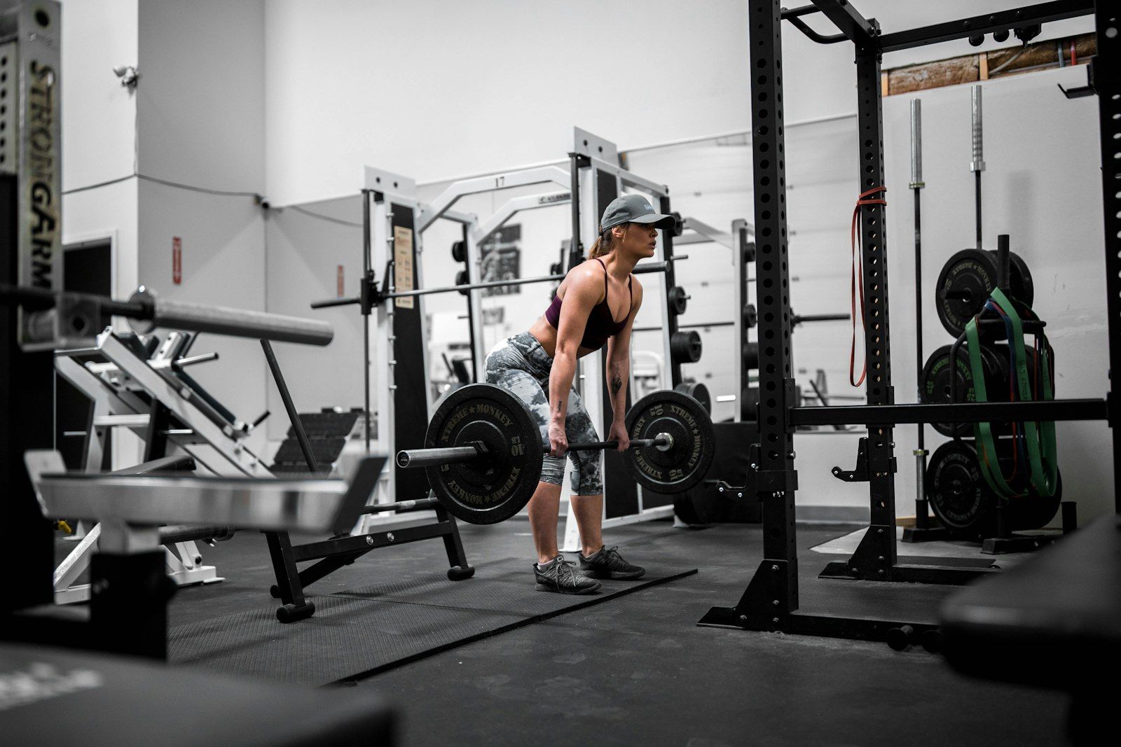 Woman performing a Romanian deadlift, one of the best exercises to grow your glutes