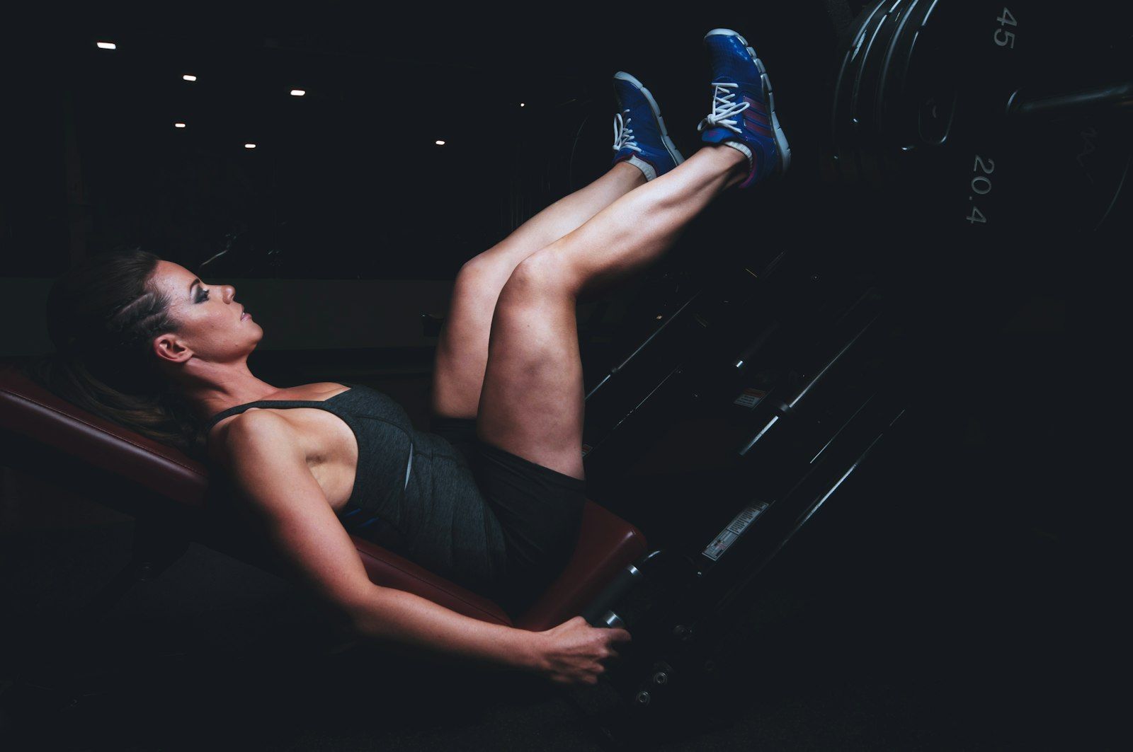 Woman training her lower body on a leg press to build stronger glutes and legs