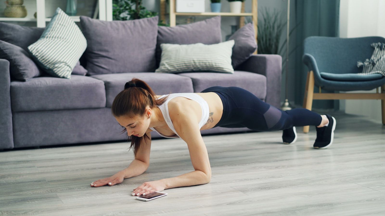 Woman following an online personal training plan at home in Phuket