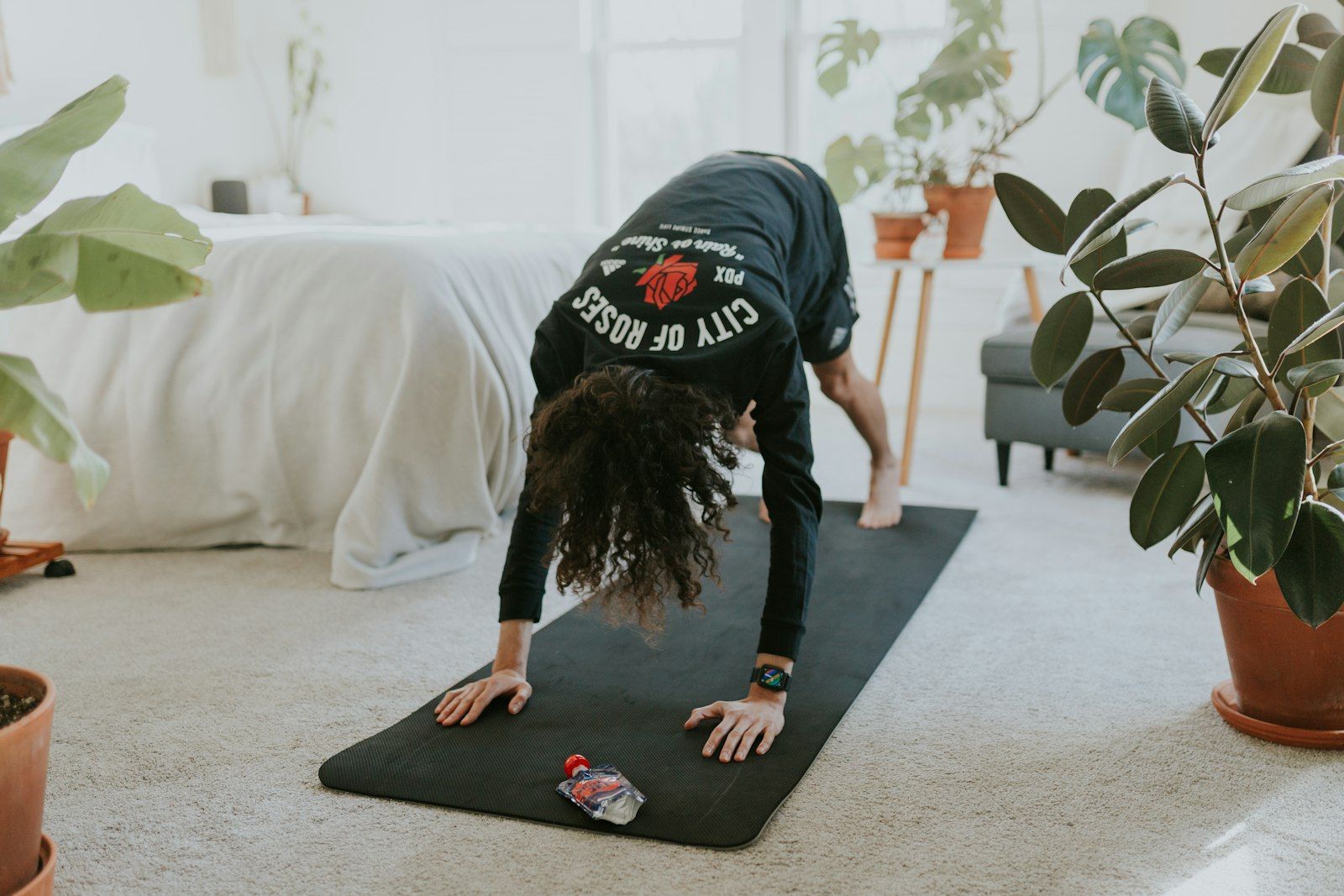 Following an online workout plan on a mat at home in Phuket