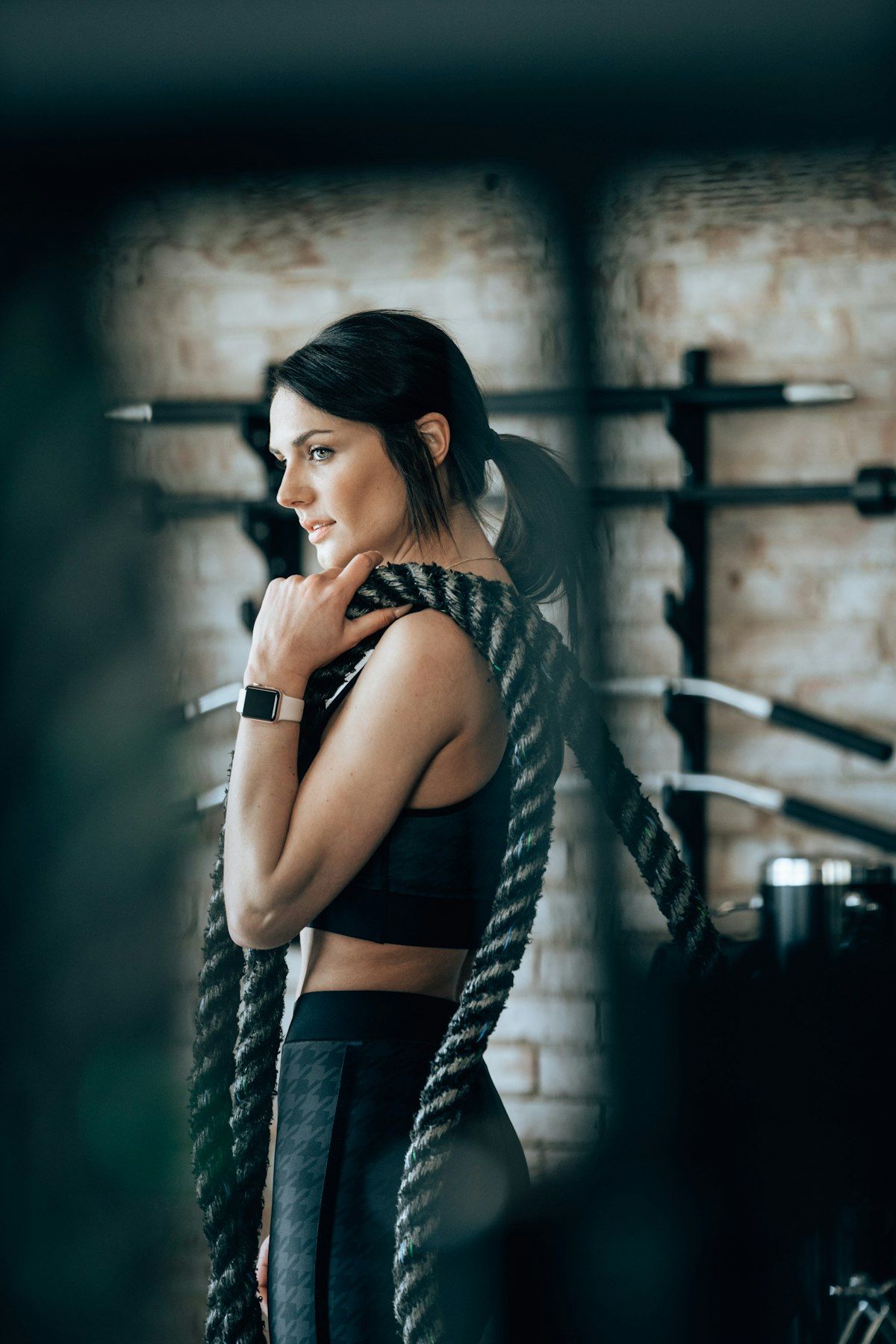 Woman training with dumbbells under a trainer's guidance in a bright Chalong studio