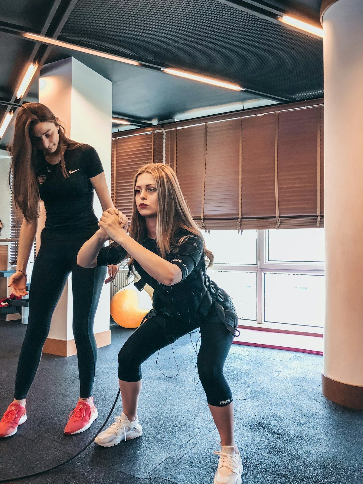 Personal trainer coaching a woman through a strength exercise in a private Chalong studio